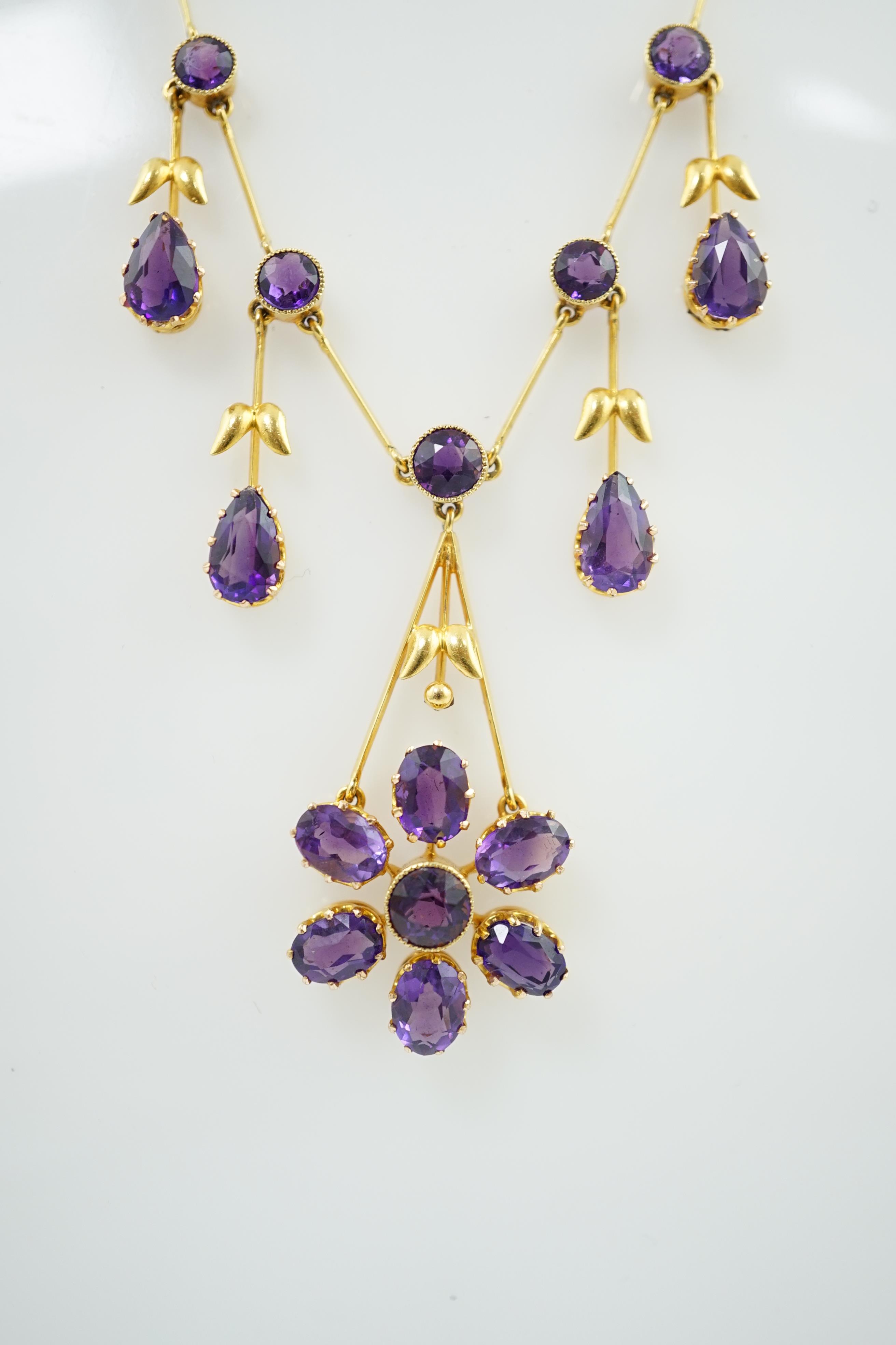 An Edwardian gold, and amethyst cluster drop pendant necklace